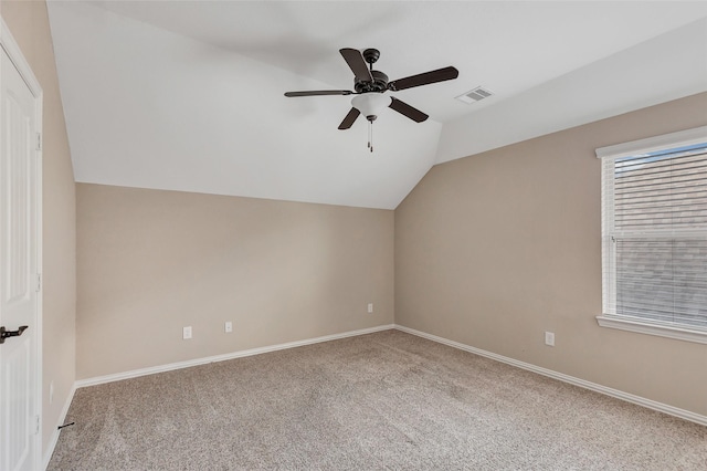 additional living space featuring vaulted ceiling, light carpet, and ceiling fan