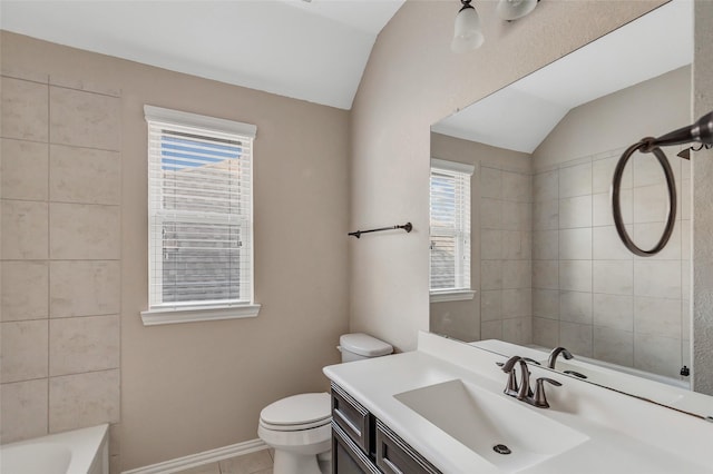 bathroom featuring vanity, vaulted ceiling, and toilet