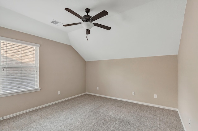 additional living space with ceiling fan, light colored carpet, and lofted ceiling