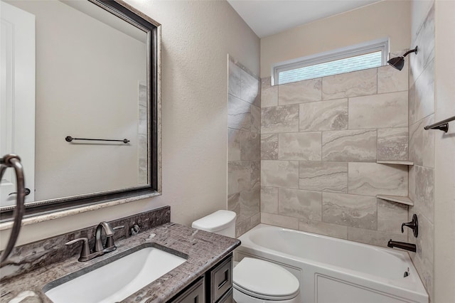 full bathroom with vanity, tiled shower / bath combo, and toilet