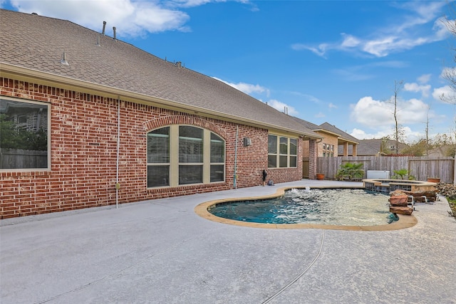 view of swimming pool featuring an in ground hot tub, pool water feature, and a patio