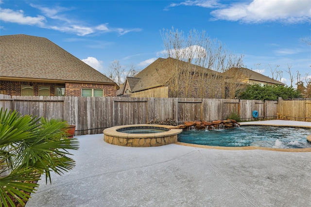 view of pool with pool water feature and an in ground hot tub