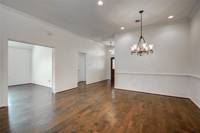 unfurnished room featuring crown molding, dark hardwood / wood-style floors, and a notable chandelier