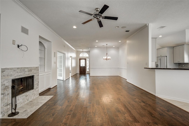 unfurnished living room with crown molding, a brick fireplace, dark hardwood / wood-style floors, and built in features