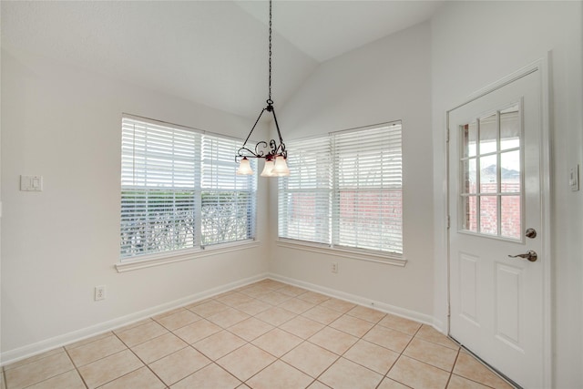 unfurnished dining area featuring a healthy amount of sunlight, lofted ceiling, and light tile patterned floors