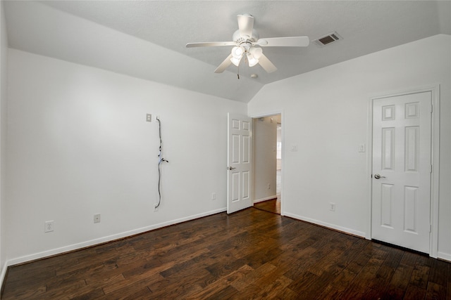 spare room featuring vaulted ceiling, dark hardwood / wood-style floors, and ceiling fan