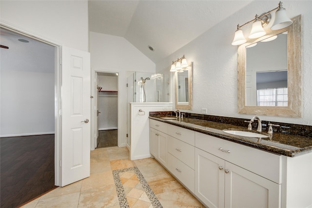 bathroom featuring vanity, an enclosed shower, and vaulted ceiling