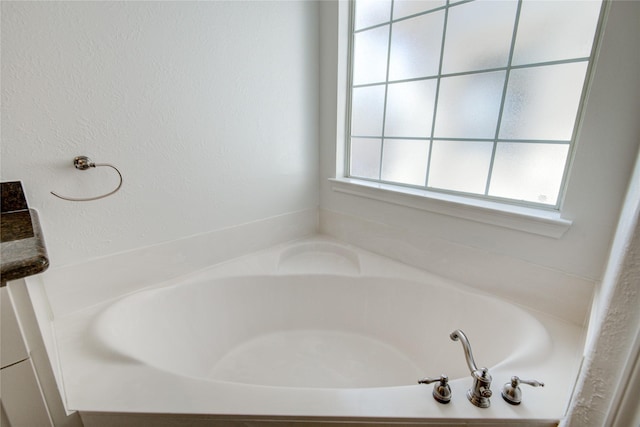 bathroom with a tub to relax in