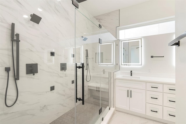 bathroom with vanity and a shower with door