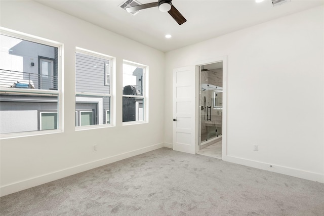 carpeted spare room featuring ceiling fan