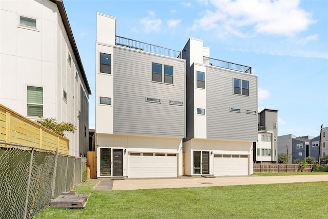 rear view of property with a yard and a garage