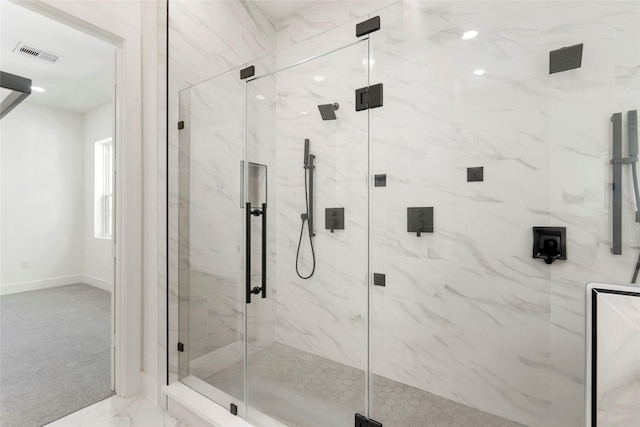 bathroom with a shower with door