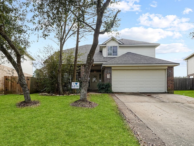 view of property with a garage and a front lawn