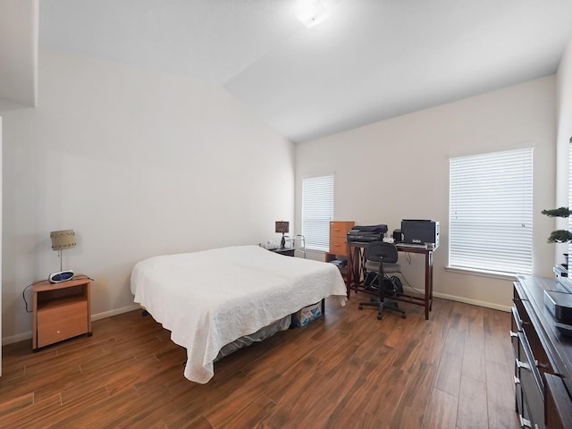 bedroom with lofted ceiling, dark hardwood / wood-style flooring, and multiple windows