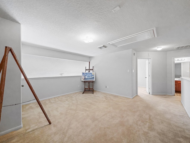 basement featuring light carpet and a textured ceiling