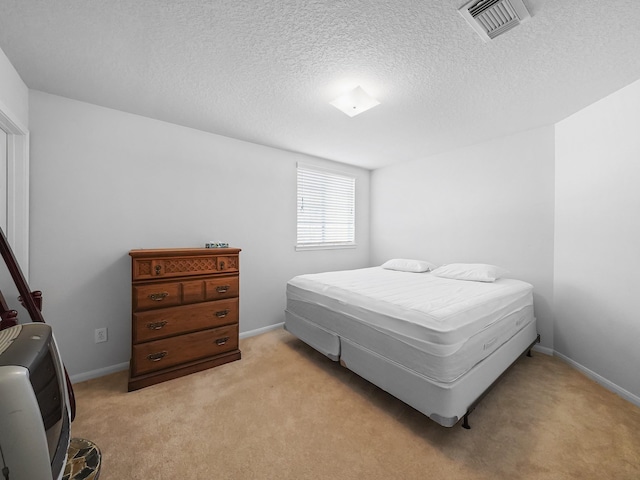 carpeted bedroom with a textured ceiling