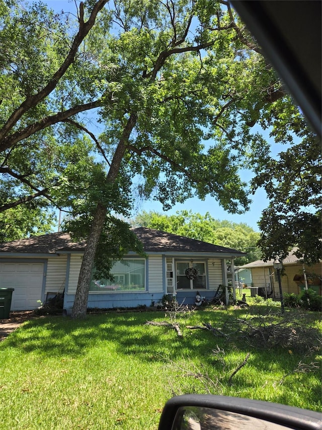 view of front of property with a garage and a front yard