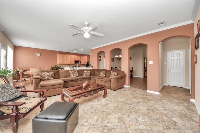 living room with ornamental molding and ceiling fan