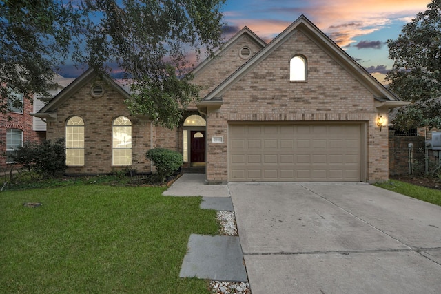 view of property featuring a yard and a garage