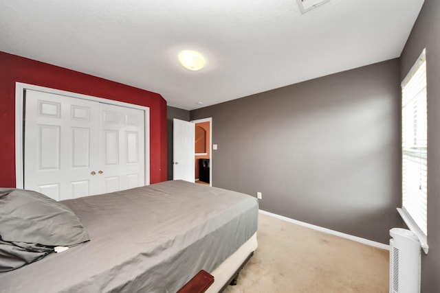 carpeted bedroom with a closet