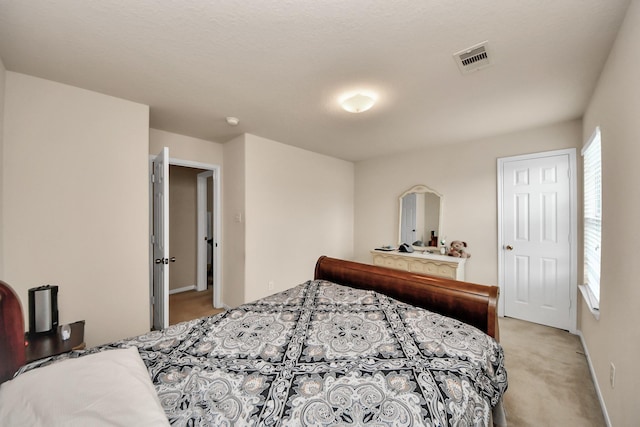 bedroom with light colored carpet