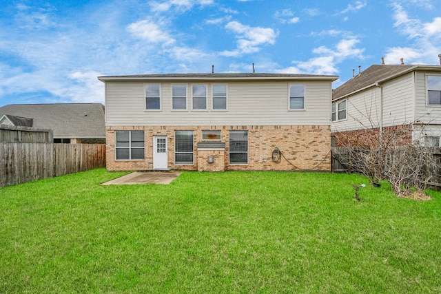 back of property featuring a yard and a patio area