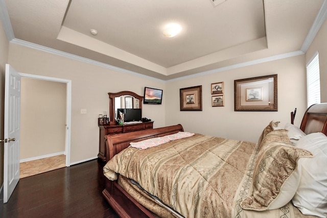 bedroom with a raised ceiling, crown molding, and dark hardwood / wood-style flooring