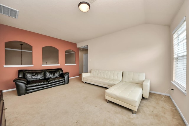 carpeted living room with lofted ceiling