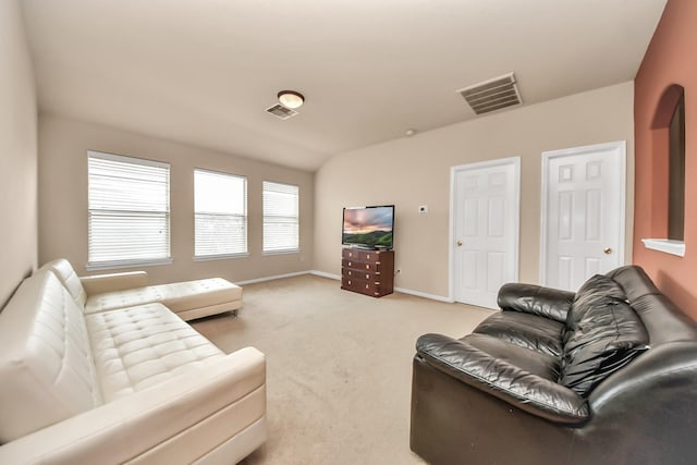 carpeted living room with lofted ceiling