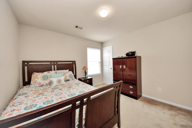 bedroom featuring light carpet