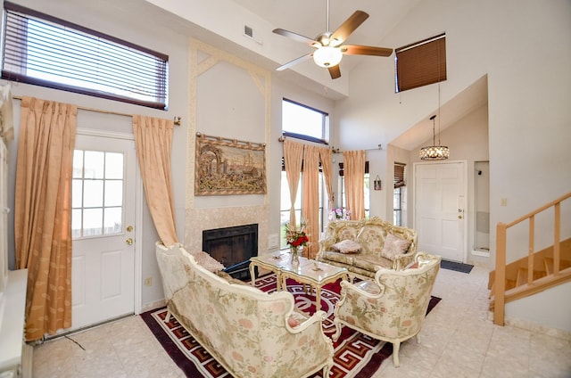 living room featuring ceiling fan, plenty of natural light, and high vaulted ceiling