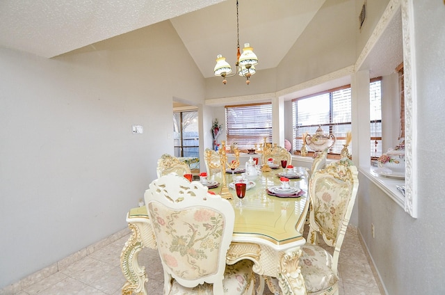 tiled dining space featuring lofted ceiling and a notable chandelier