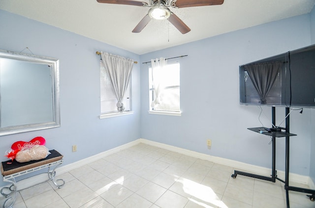 tiled spare room featuring ceiling fan