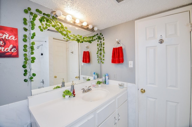 bathroom featuring vanity and a textured ceiling