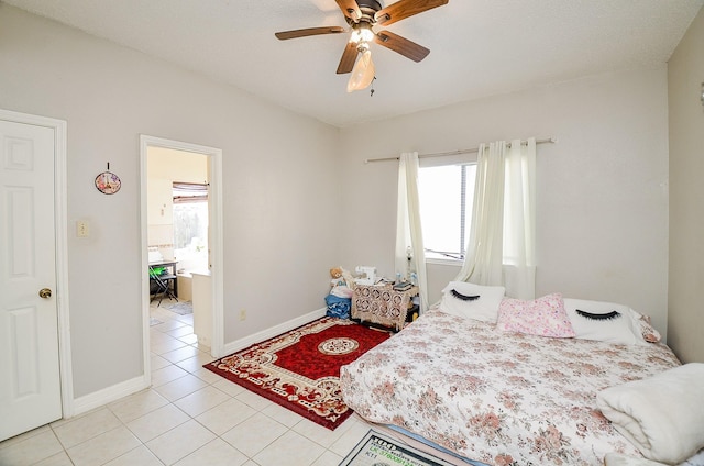 bedroom featuring light tile patterned flooring and ceiling fan