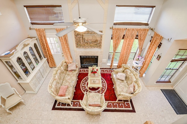 living room featuring tile patterned flooring, a towering ceiling, and ceiling fan