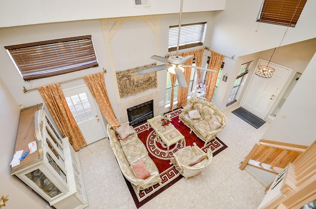 living room featuring ceiling fan and a high ceiling