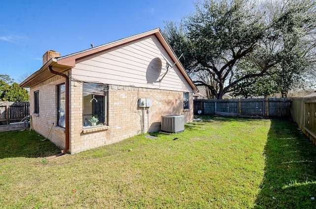 view of side of home featuring a lawn and central air condition unit