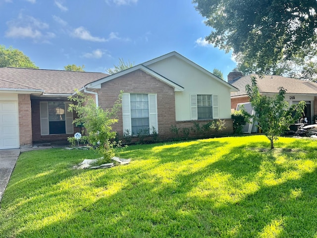 single story home featuring a garage and a front lawn