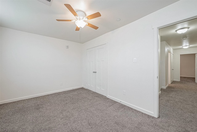 carpeted spare room with ceiling fan