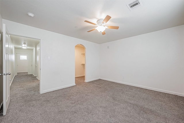 carpeted spare room featuring ceiling fan