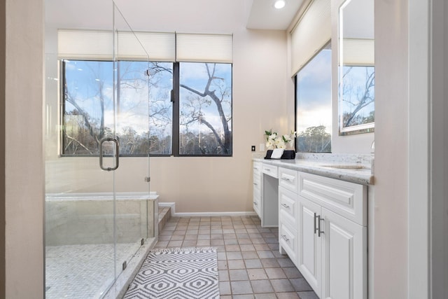 bathroom featuring vanity, tile patterned flooring, and a shower with shower door