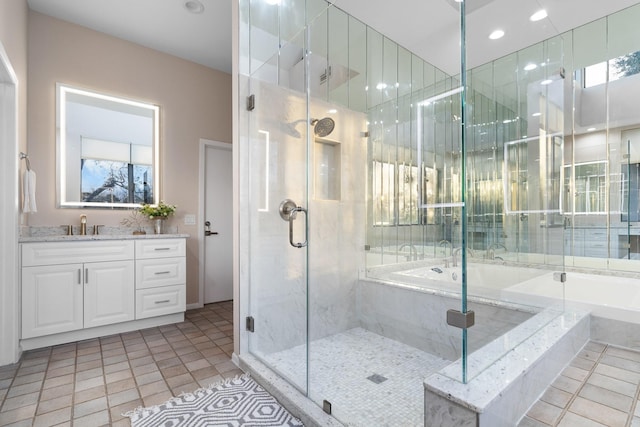 bathroom with vanity, tile patterned flooring, and plus walk in shower