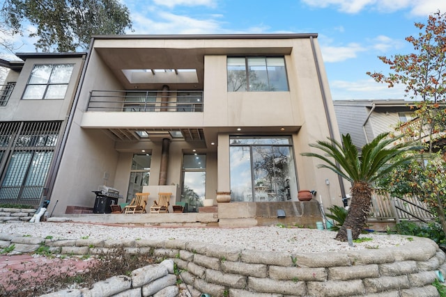 rear view of property featuring a balcony