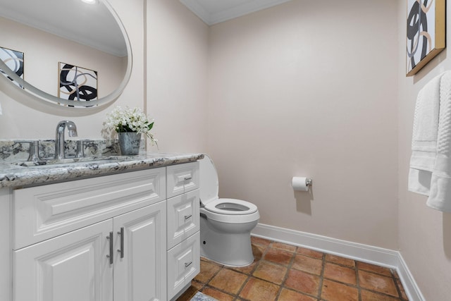 bathroom featuring vanity, crown molding, and toilet