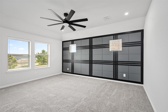 carpeted empty room featuring ceiling fan