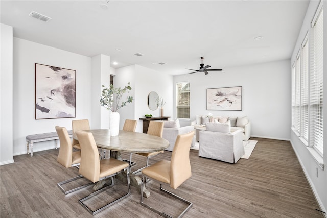 dining space with hardwood / wood-style flooring and ceiling fan