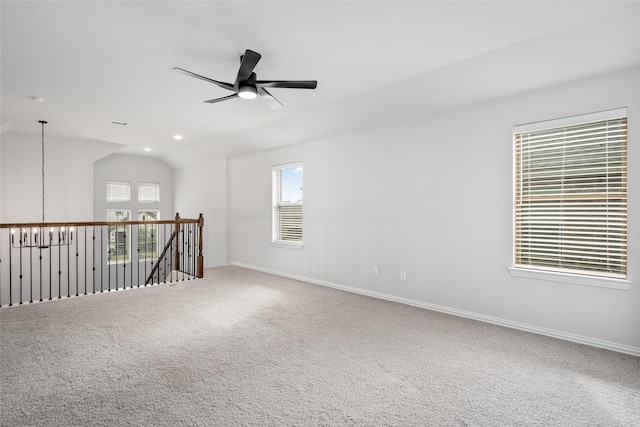 unfurnished room with lofted ceiling, a wealth of natural light, carpet, and ceiling fan