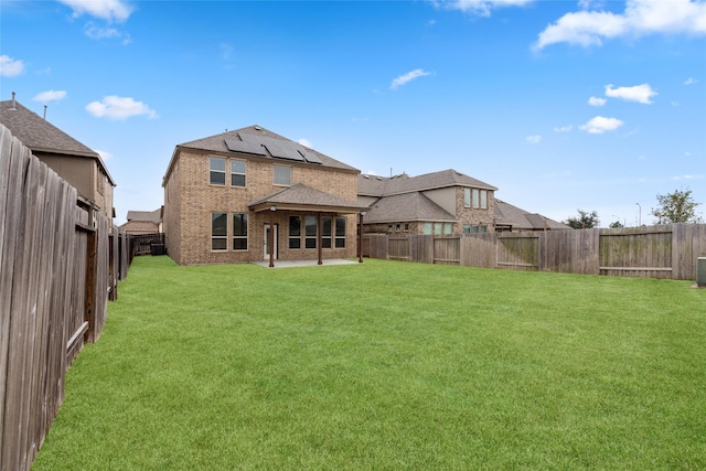 back of house with a yard and a patio area