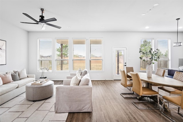 living room with hardwood / wood-style floors and ceiling fan